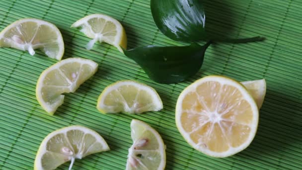 sliced lemon on a green background - Footage, Video