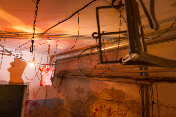 Terrible bloody female torso hanging from chains in basement wit - Photo, image