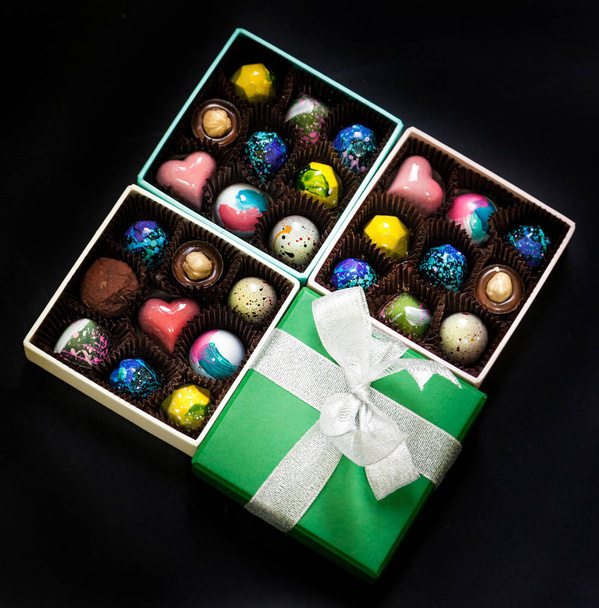Chocolate handmade candy sweets in a gift boxes. Black background. - Fotó, kép