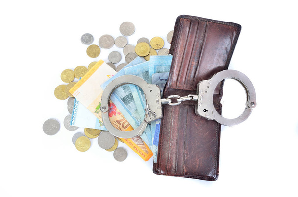 Cash money and handcuffs. the concept of crime and corruption - Φωτογραφία, εικόνα