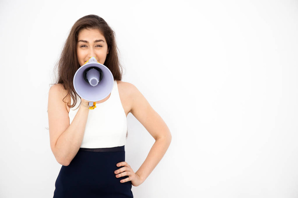 Young beautiful Caucasian woman shouting and making announcement with megaphone in white isolated background - Fotó, kép