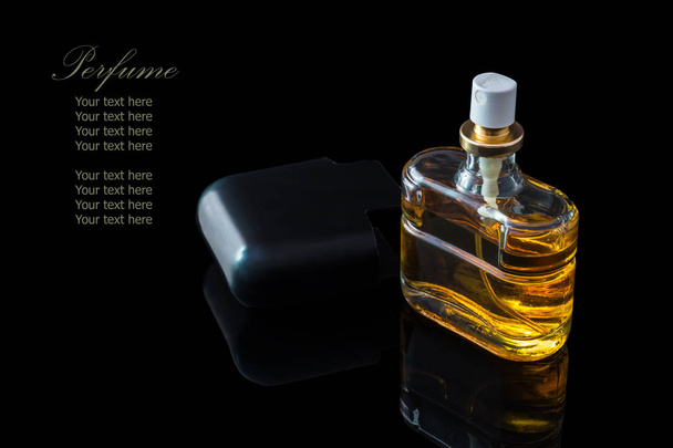Perfume bottle isolated on black background with reflexion. - Photo, Image