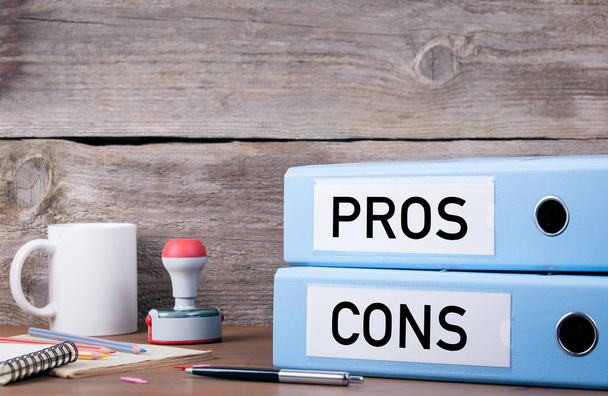 Pros and Cons. Two binders on desk in the office. Business backg - Photo, Image
