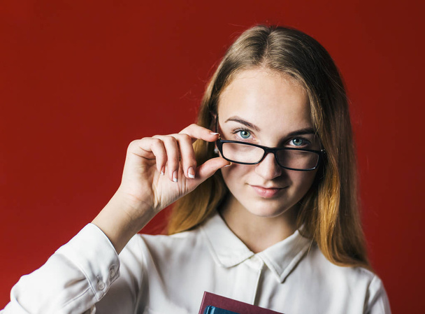 Attractive Student Blonde Girl with Glasses on Red - Fotoğraf, Görsel