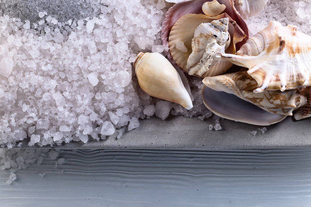 Sea salt with stones and shells on a old wooden table  - Photo, Image