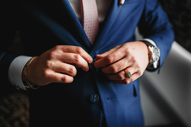 Closeup of man buttoning his jacket, business clothing concept - Foto, afbeelding