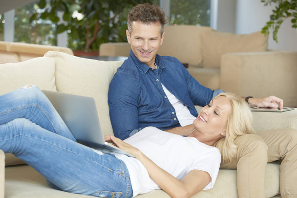 couple relaxing on her cozy couch - Photo, Image