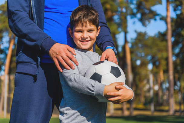 Happy kid with ball near parent - Foto, immagini