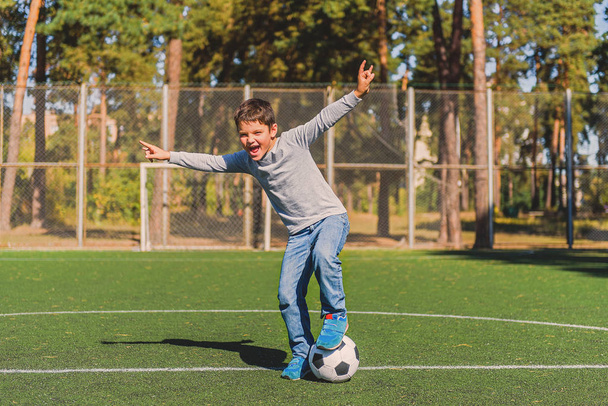 Joyful child celebrating success in football - Fotoğraf, Görsel