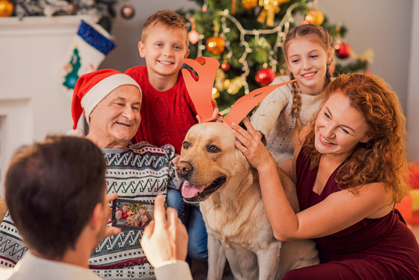 Happy relatives having fun with pet on holiday - Valokuva, kuva