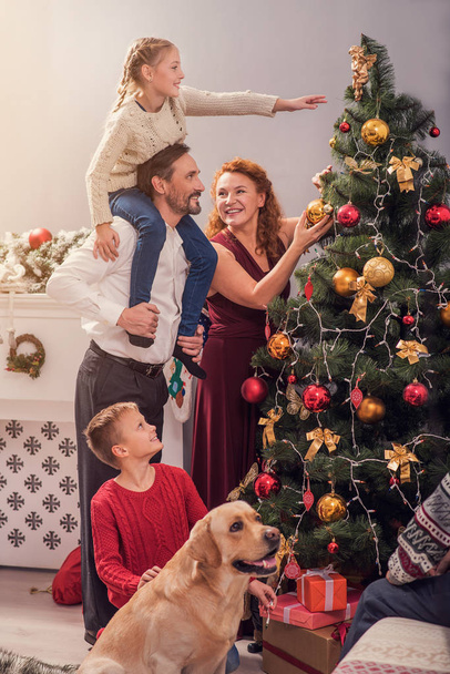 Friendly family decorating fir-tree at home - Foto, immagini