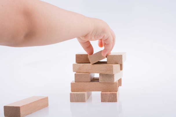 Hand playing with wooden building blocks - Photo, Image