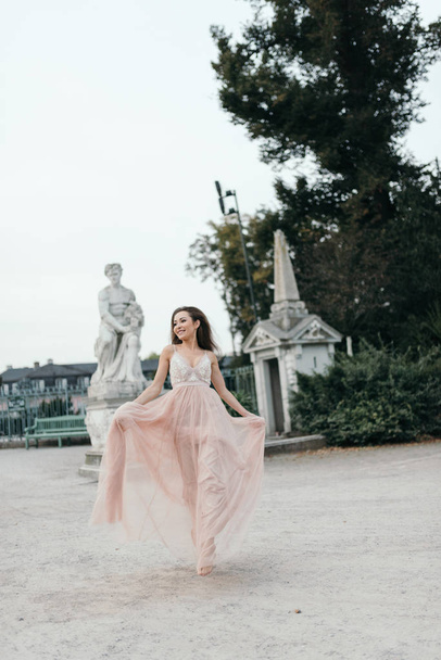 Young beautiful woman in long rose evening dress  - Фото, зображення