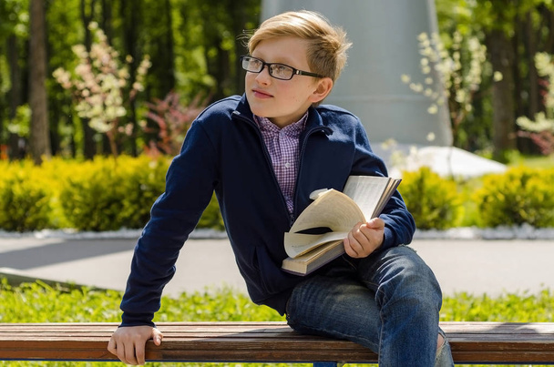 Teenager is reading a book - Фото, зображення