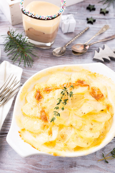 Delicious Christmas themed dinner table with potato gratin - Photo, Image