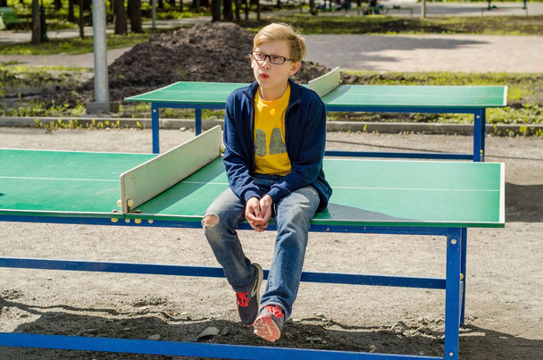 Teenager is sitting  in the park - Zdjęcie, obraz
