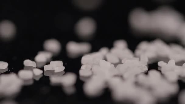 Close-up of grains of salt on a black background - Footage, Video