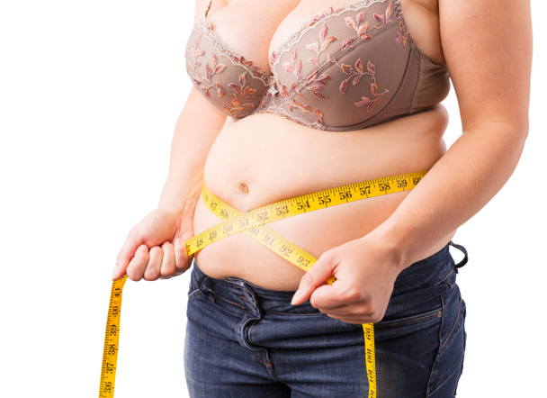 Woman measuring her fat belly - Photo, Image