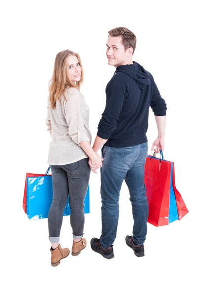 Full body of couple holding bunch of shopping bags - Fotó, kép