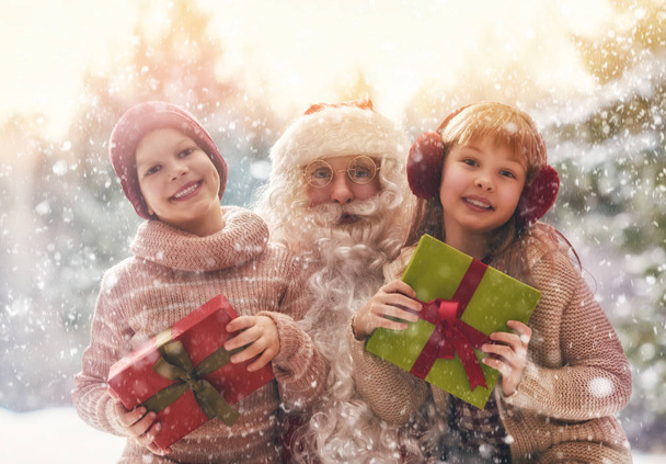Santa Claus presents gifts - Фото, зображення