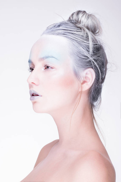 Model in creative image with silver blue artistic make-up - Photo, image