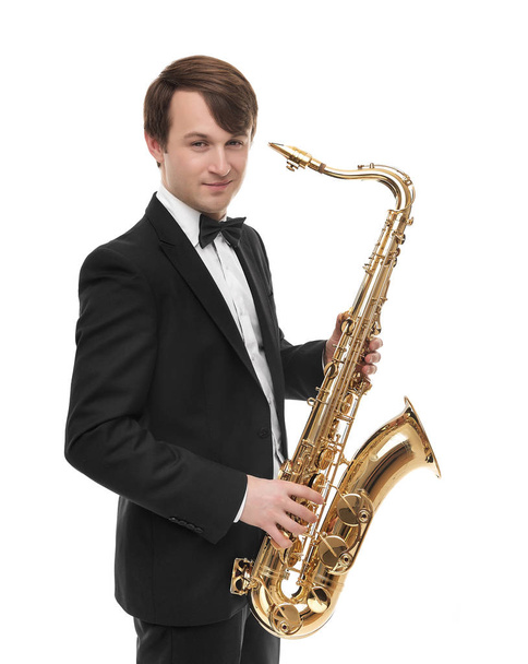 Attractive saxophonist with a saxophone in a suit. - Фото, изображение