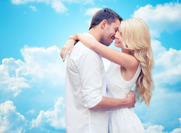 happy couple hugging over blue sky - Photo, Image