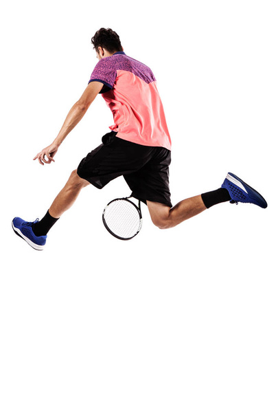 Tennispelaaja hyppää pallon takaa
 - Valokuva, kuva