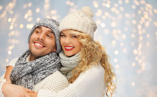 happy family couple in winter clothes hugging - Foto, imagen