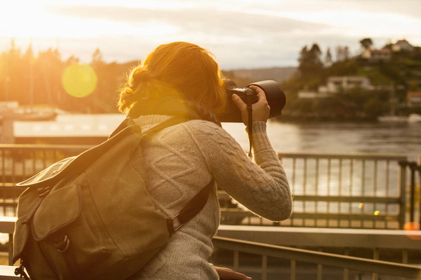 girl photographing sunset - Фото, изображение