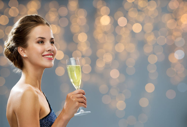 smiling woman holding glass of champagne - Φωτογραφία, εικόνα