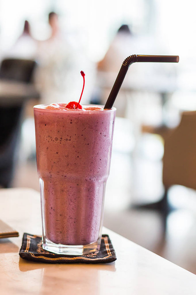 Strawberry smoothie on table and blurred background - Photo, Image