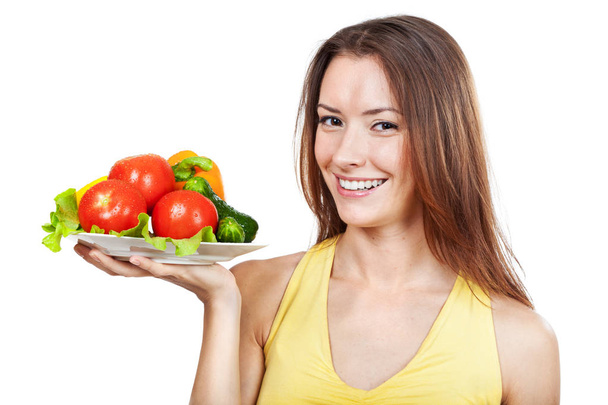 woman holding plate of fresh vegetables - Zdjęcie, obraz
