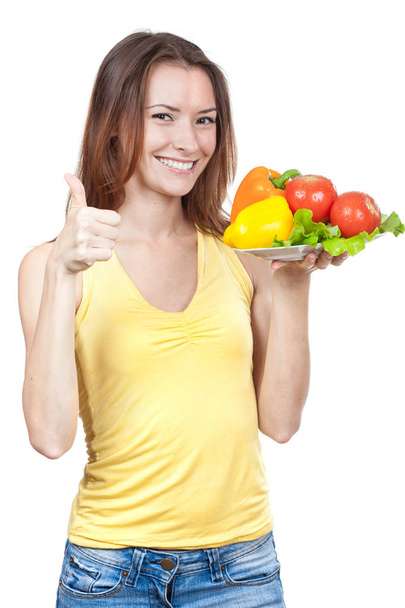 woman holding plate of fresh vegetables - Fotoğraf, Görsel