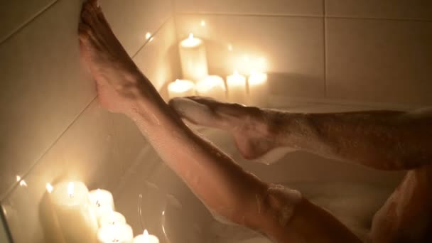 legs of a beautiful young woman who takes a bath - Felvétel, videó