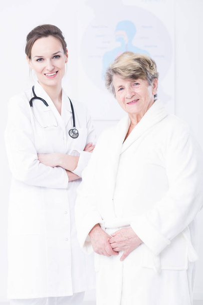 Elder woman and young doctor - Фото, изображение