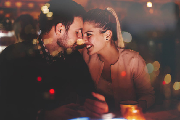 Romantic couple dating in pub - Фото, изображение