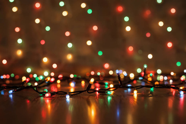 Christmas lights on a wooden background - Foto, imagen