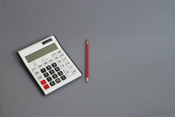 white calculator and pencil on office desk - Fotoğraf, Görsel
