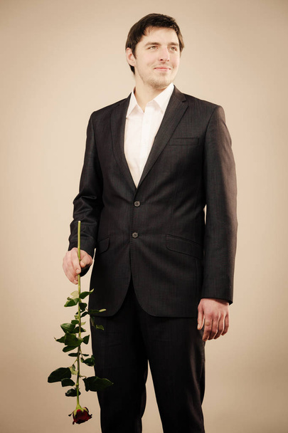 Handsome man with rose - Фото, изображение