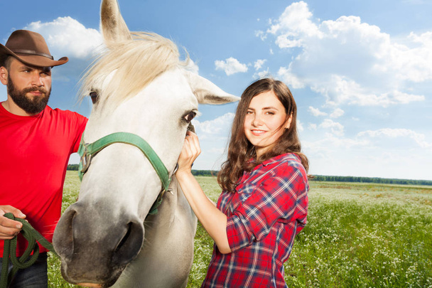 couple with their white horse - Photo, image