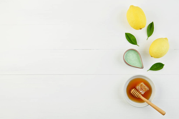 Homemade lemon salt bath and fresh honey in the plate with honey - Photo, Image