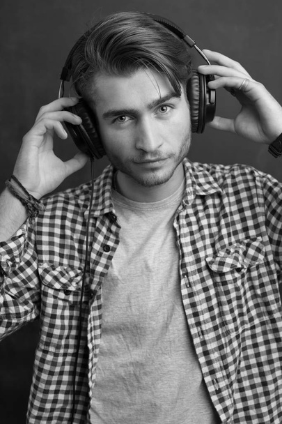 portrait of a young man listening to music - Fotó, kép