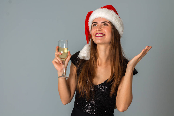 young girl in santa hat with glass of champagne - Foto, Imagen