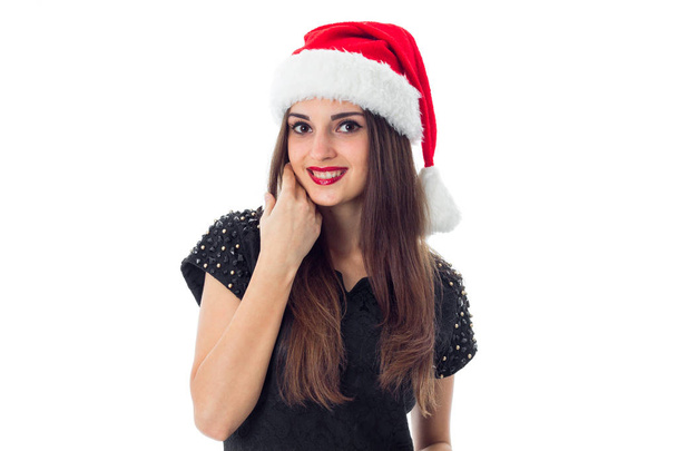 adorable brunette girl in santa hat - Fotó, kép