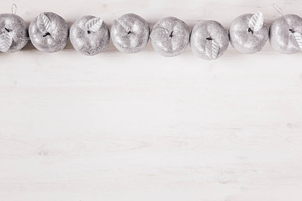 Christmas silver apples decoration  on wooden white background.  - 写真・画像