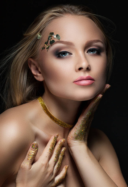 beautiful blonde with golden make-up. Beauty fashion. Face close-up - Photo, Image