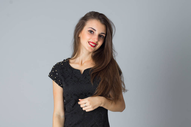 girl in black dress posing in studio - Fotó, kép