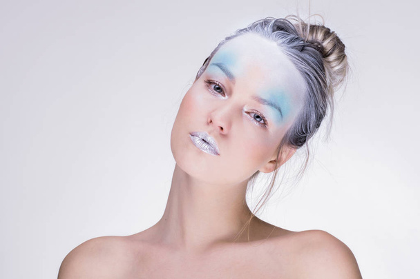 Model in creative image with silver blue artistic make-up - Foto, Imagem