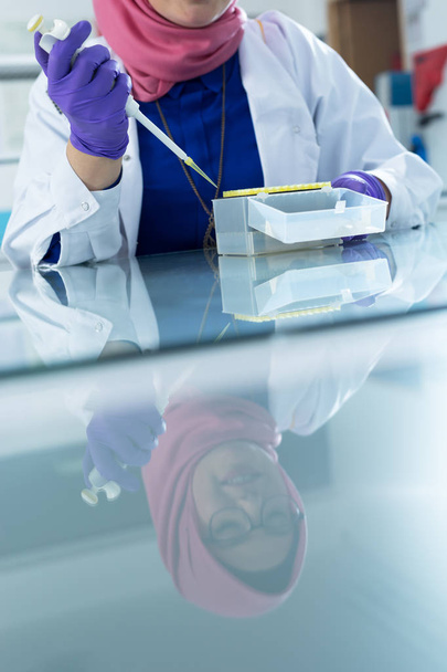 muslim lab worker with hijab  - 写真・画像
